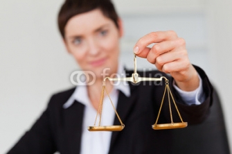 Serious_businesswoman_holding_the_justice_scale.jpg